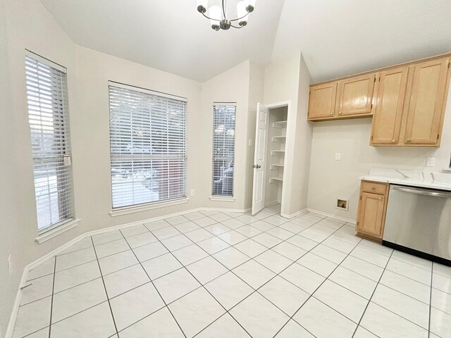 kitchen featuring dishwasher, a healthy amount of sunlight, light brown cabinetry, and vaulted ceiling