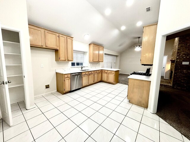 kitchen with lofted ceiling, a brick fireplace, stainless steel dishwasher, ceiling fan, and light tile patterned floors