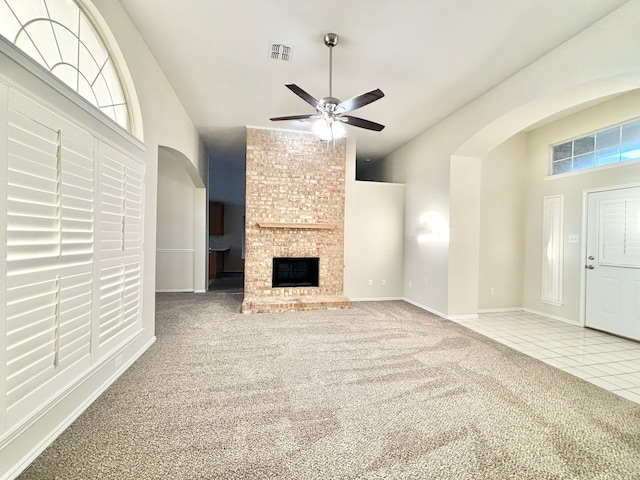 unfurnished living room with a fireplace, carpet floors, and ceiling fan