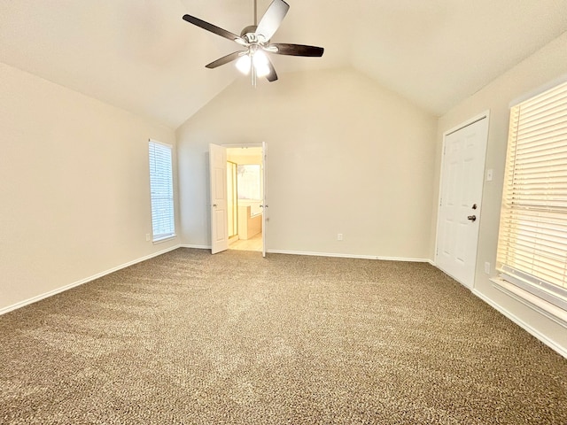 unfurnished bedroom featuring carpet flooring, multiple windows, lofted ceiling, and ceiling fan