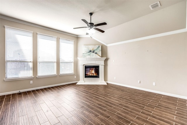 unfurnished living room featuring crown molding, dark wood-type flooring, vaulted ceiling, and ceiling fan