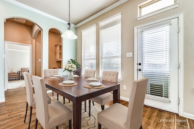 dining area featuring crown molding