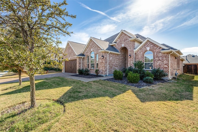 front facade with a garage and a front lawn