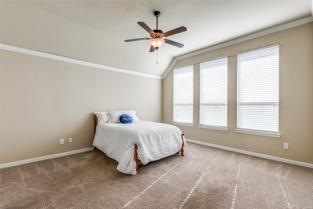 bedroom featuring ceiling fan, lofted ceiling, carpet floors, and ornamental molding