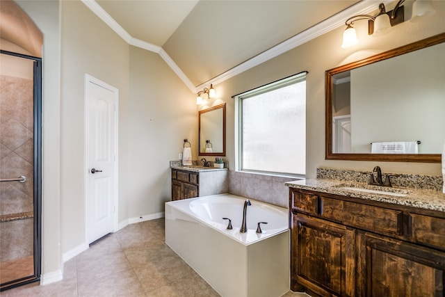 bathroom featuring lofted ceiling, vanity, ornamental molding, tile patterned floors, and a bathing tub