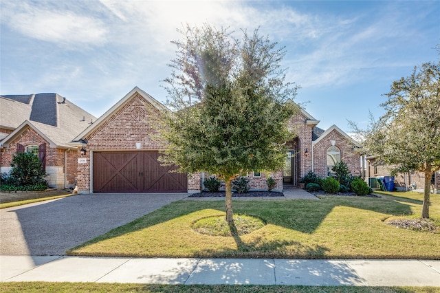 view of front of home featuring a garage and a front lawn