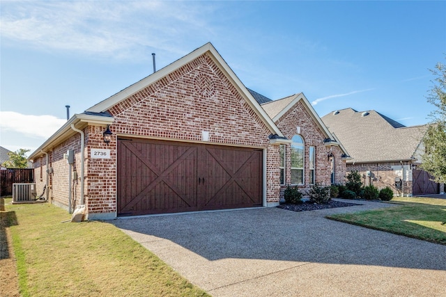 view of front of house featuring cooling unit, a garage, and a front lawn