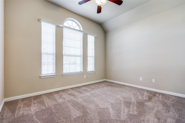 carpeted empty room with ceiling fan and lofted ceiling