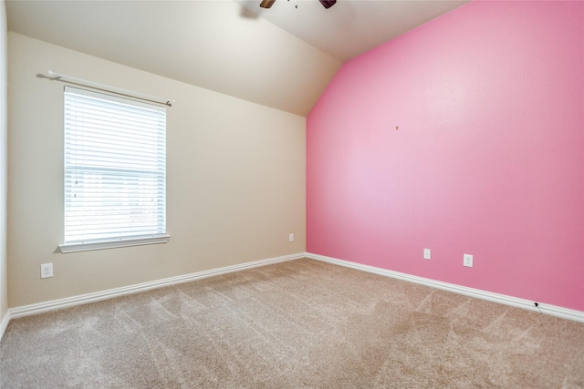 carpeted spare room with lofted ceiling and ceiling fan