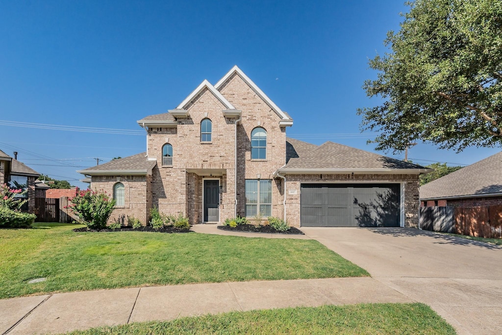 view of front of property featuring a garage and a front yard