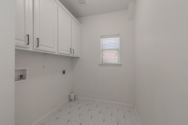 washroom featuring electric dryer hookup, washer hookup, and cabinets