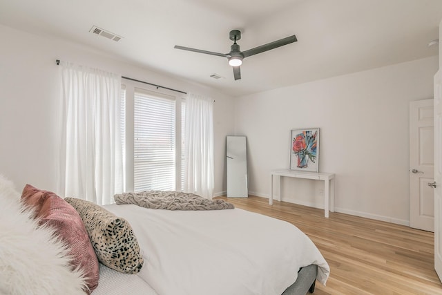 bedroom with light hardwood / wood-style flooring and ceiling fan