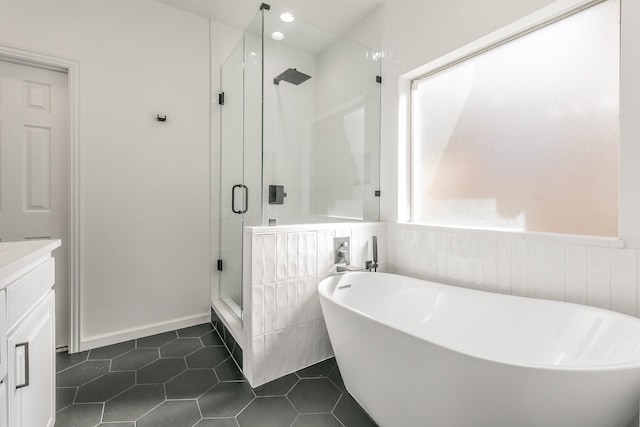 bathroom featuring tile patterned flooring, vanity, and independent shower and bath