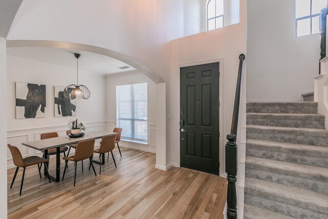 living room with a large fireplace, plenty of natural light, ceiling fan, and light hardwood / wood-style flooring