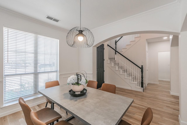 dining room featuring crown molding and light wood-type flooring