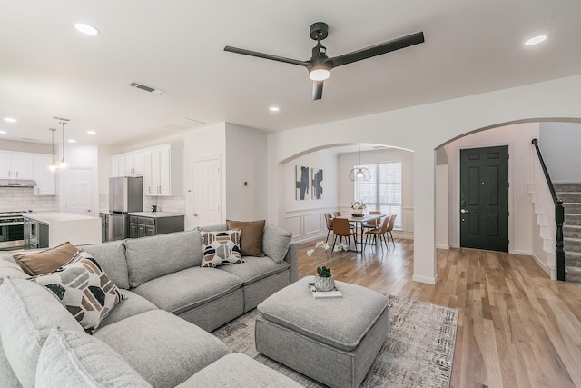 living room featuring ceiling fan and light hardwood / wood-style floors