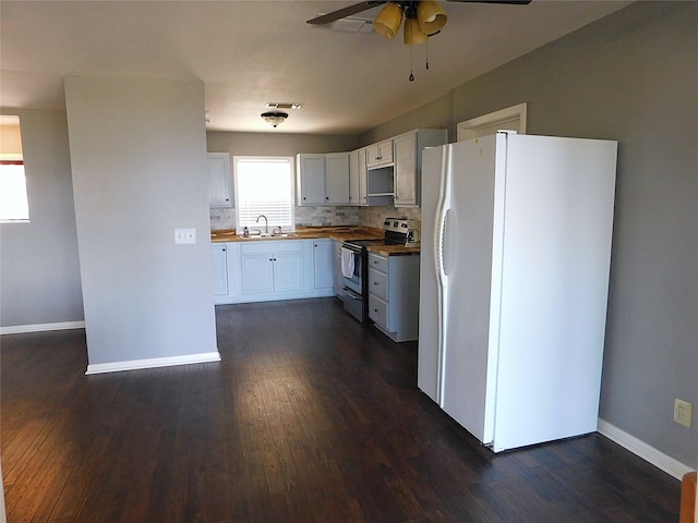 kitchen with stainless steel electric range oven, white cabinetry, sink, white refrigerator with ice dispenser, and butcher block countertops