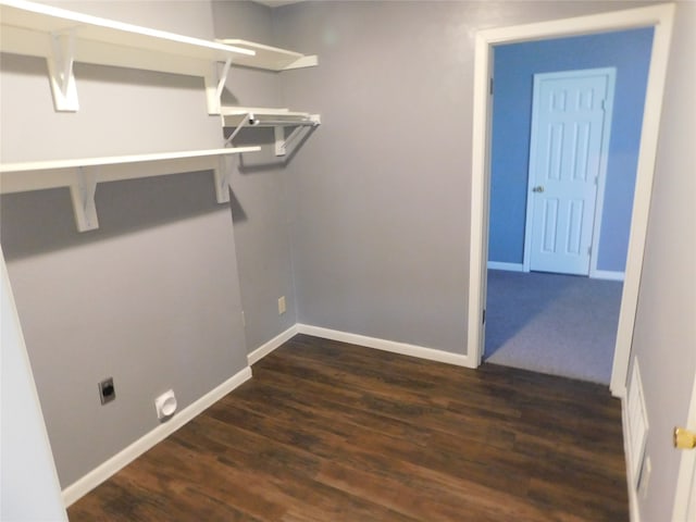 laundry area with dark wood-type flooring and hookup for an electric dryer