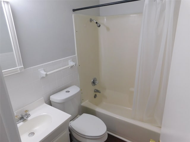 full bathroom featuring vanity, shower / bathtub combination with curtain, toilet, and tile walls