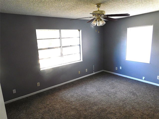 carpeted spare room with a textured ceiling and ceiling fan