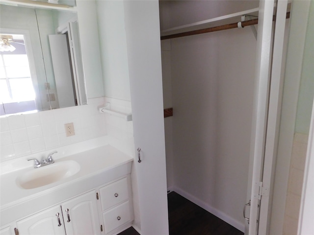 bathroom featuring decorative backsplash and vanity