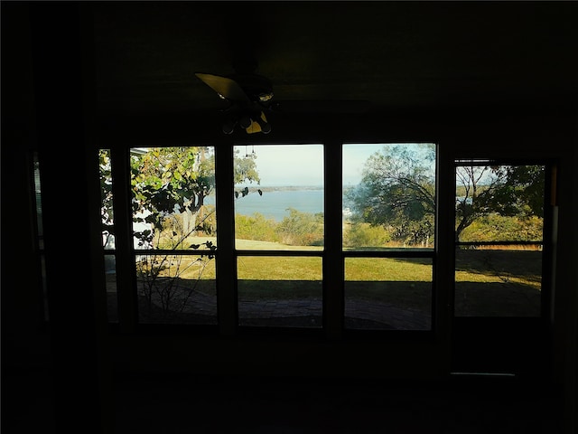 entryway featuring a water view and ceiling fan