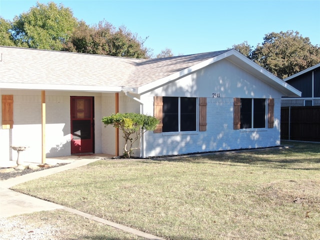 view of side of home with a yard