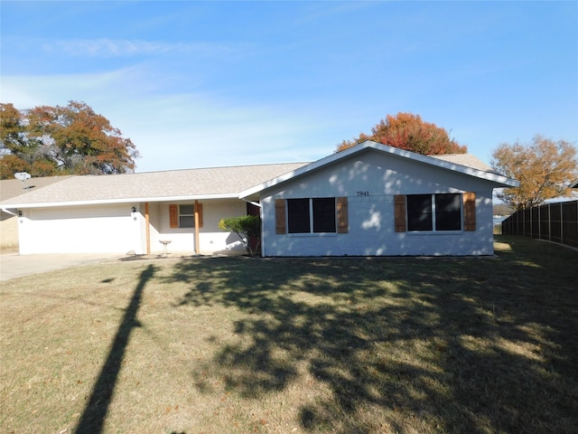 single story home featuring a garage and a front lawn