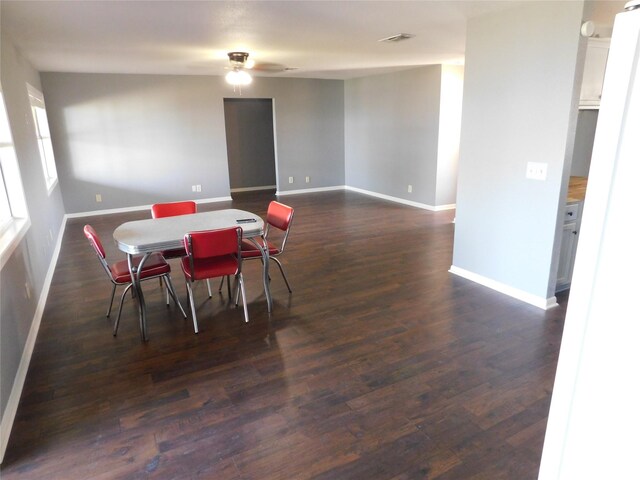 dining area featuring ceiling fan and dark hardwood / wood-style flooring