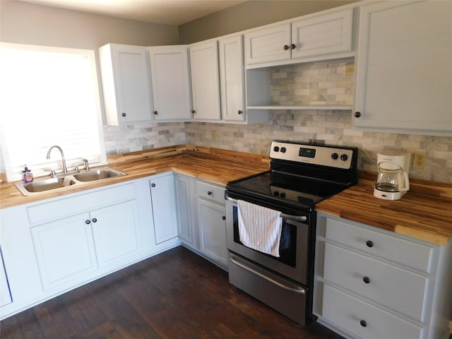 kitchen featuring butcher block counters, white cabinetry, and stainless steel range with electric cooktop