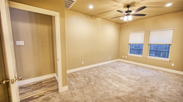 carpeted spare room with ceiling fan