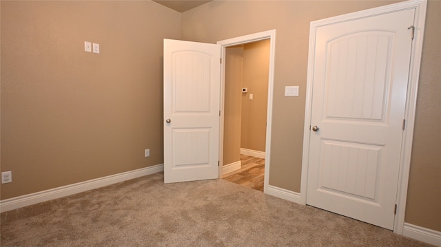 unfurnished bedroom with light colored carpet