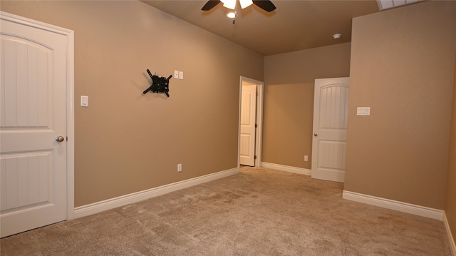 carpeted spare room with ceiling fan