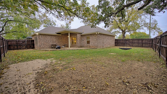 rear view of property with a lawn and a patio area