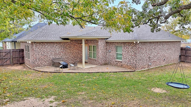 rear view of property featuring a lawn and a patio