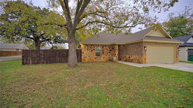 view of front of home featuring a front yard and a garage