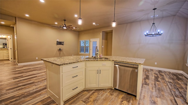 kitchen with dishwasher, a kitchen island with sink, sink, hardwood / wood-style flooring, and white cabinetry