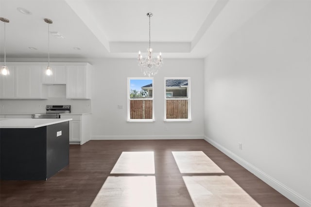 kitchen featuring white cabinetry, dark wood-type flooring, hanging light fixtures, stainless steel electric range, and a tray ceiling