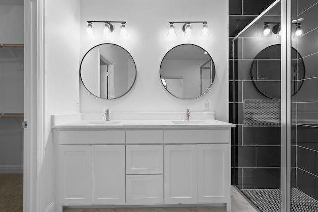 bathroom featuring vanity and an enclosed shower