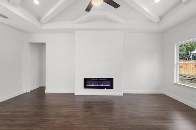 unfurnished living room with beam ceiling, ceiling fan, and dark hardwood / wood-style floors