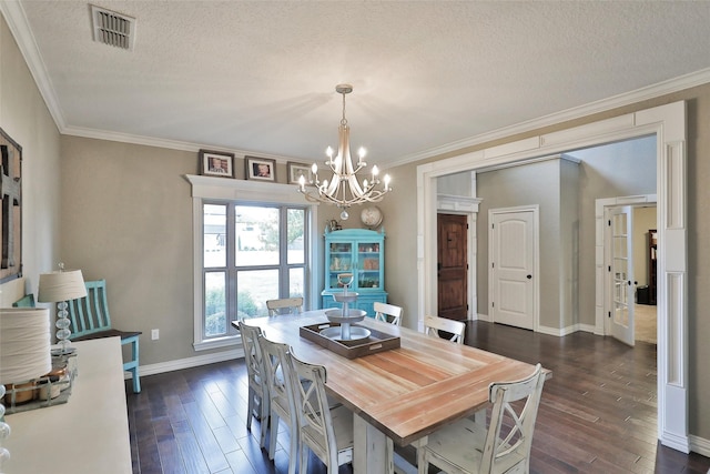 dining space featuring a textured ceiling, ornamental molding, dark hardwood / wood-style floors, and a notable chandelier