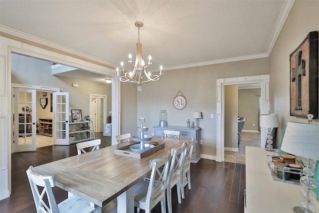 dining room featuring a chandelier, french doors, dark hardwood / wood-style floors, and ornamental molding