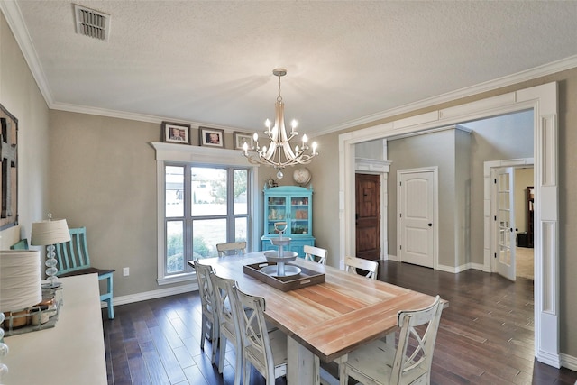 118 Prairie Creek Way, Abilene, TX 79602 - dining room featuring a chandelier, a textured ceiling, dark wood-type flooring, crown molding, and baseboards
