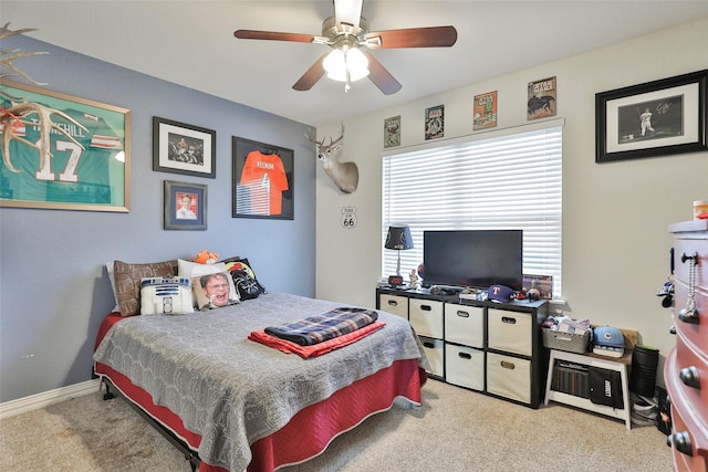 bedroom with ceiling fan and light carpet