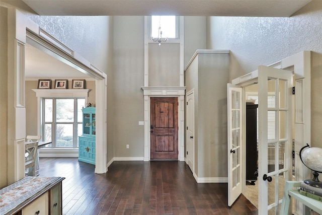 118 Prairie Creek Way, Abilene, TX 79602 - foyer with french doors, a towering ceiling, dark wood-type flooring, a chandelier, and baseboards