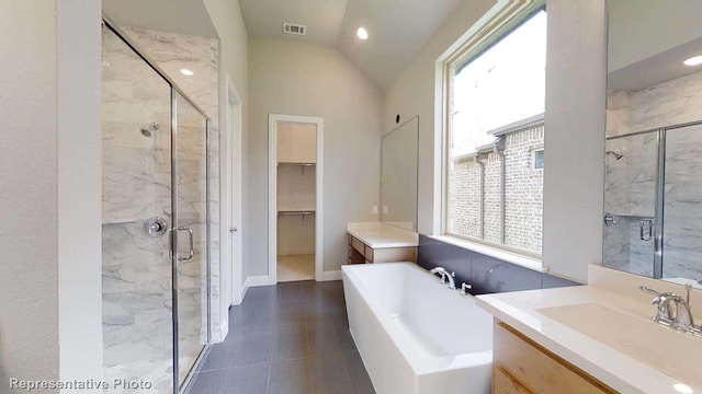 bathroom featuring a healthy amount of sunlight, vanity, separate shower and tub, and lofted ceiling