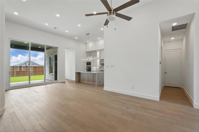 823 Shady Oaks Dr, Rockwall, TX 75087 - unfurnished living room with light wood-style floors, ceiling fan, baseboards, and recessed lighting