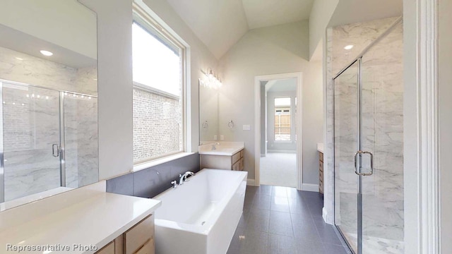 bathroom featuring separate shower and tub, vanity, and lofted ceiling