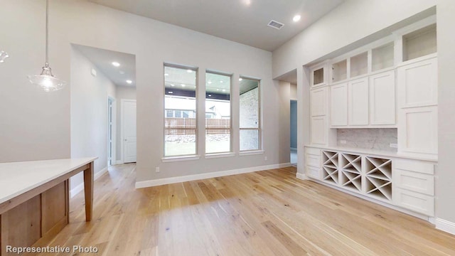 unfurnished dining area featuring light hardwood / wood-style floors