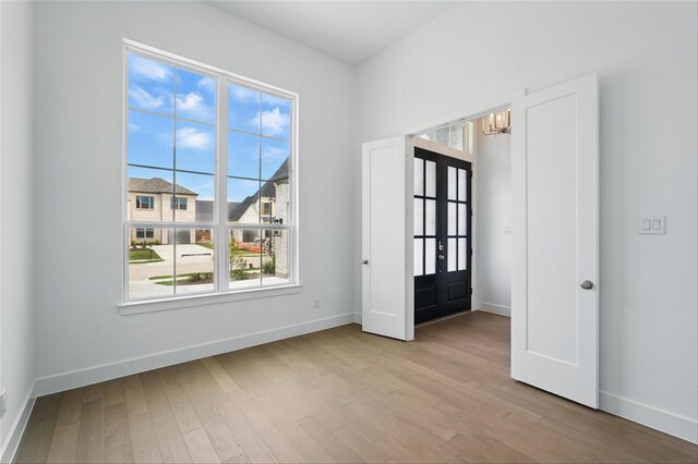 823 Shady Oaks Dr, Rockwall, TX 75087 - spare room featuring wood finished floors, a chandelier, baseboards, and french doors